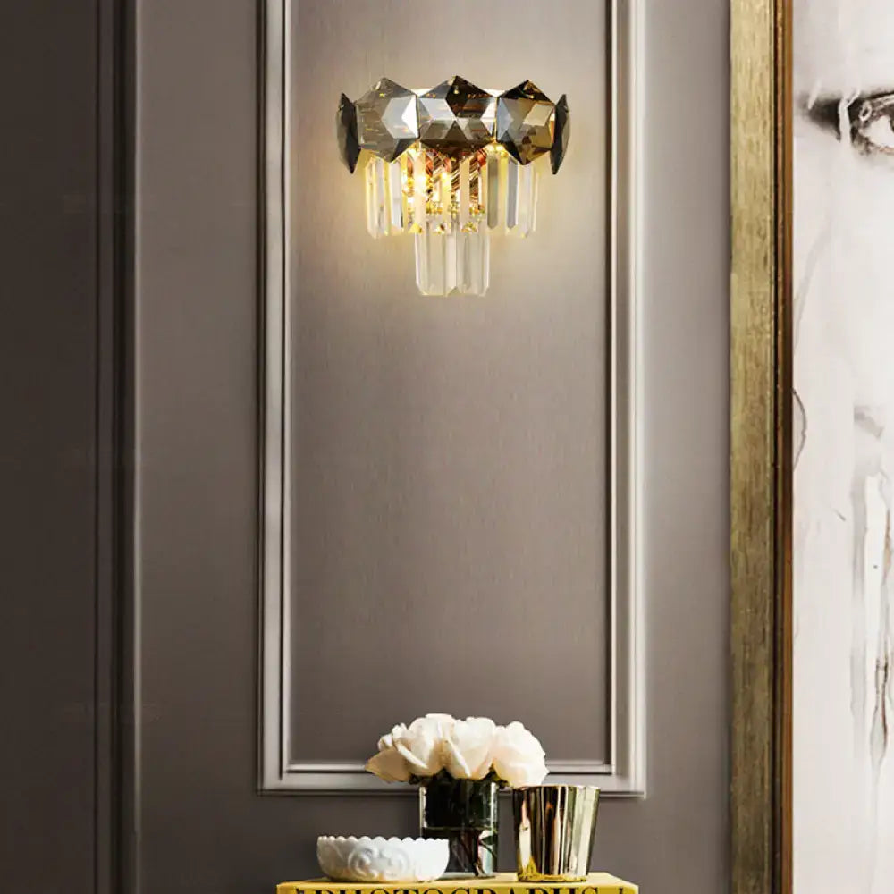 Modern gray and gold faceted crystal wall light fixture with clear glass prisms on a sleek metallic frame for restaurants