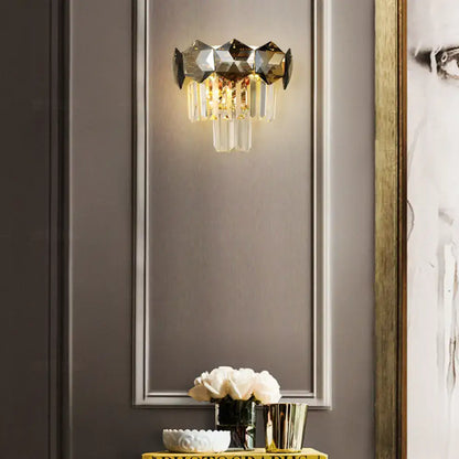 Modern gray and gold faceted crystal wall light fixture with clear glass prisms on a sleek metallic frame for restaurants