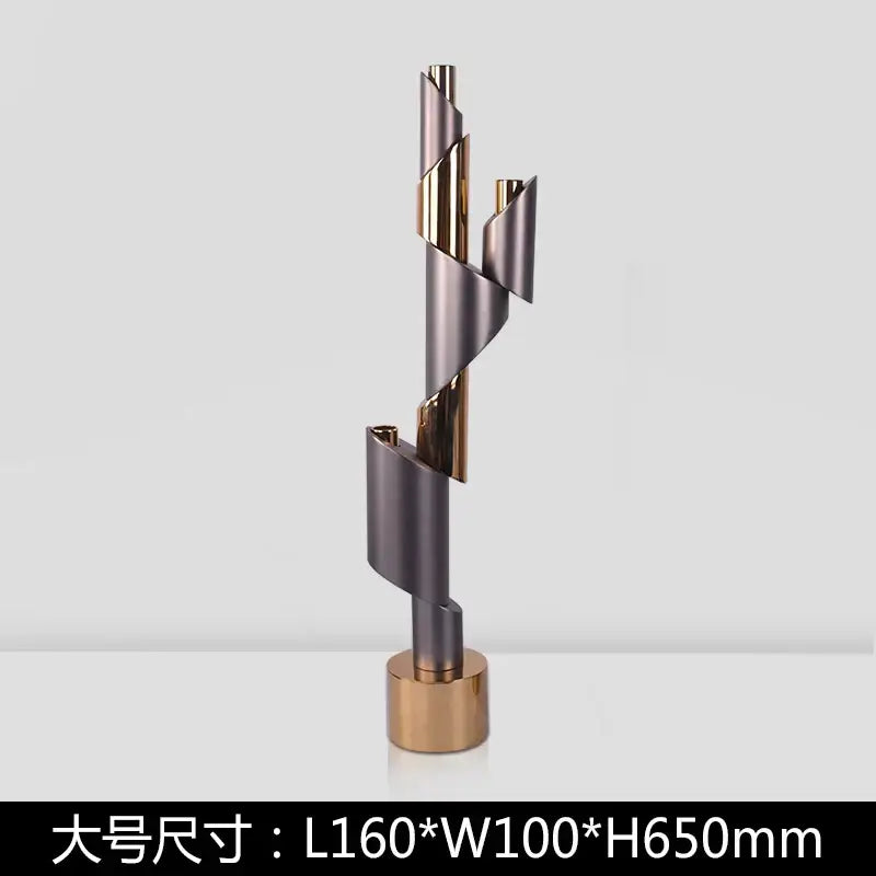 Modern gray and gold helical pipe candle holder with twisted metallic tubes on a circular brass base decorbites geometric helical