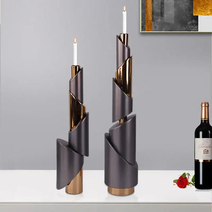 Two modern gray and gold metallic helical pipe candle holders with white taper candles for dining room decorbites geometric decor