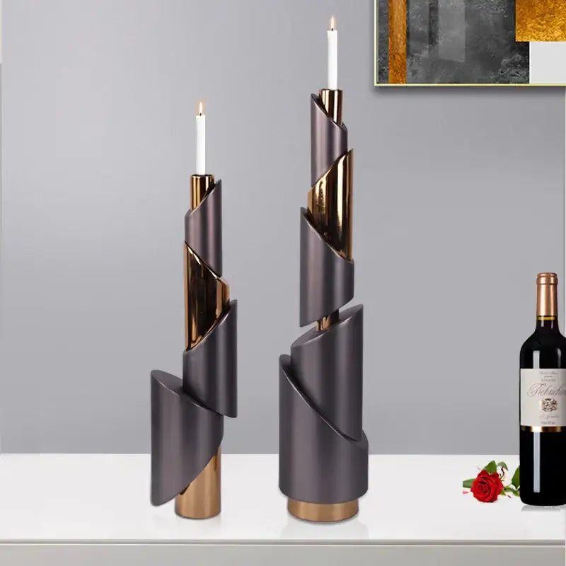 Two modern gray and gold metallic helical pipe candle holders with white taper candles for dining room decorbites geometric decor