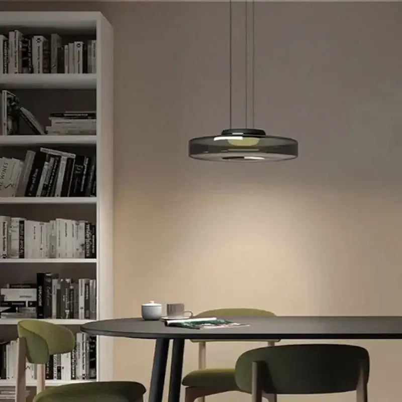 Modern gray and green tiered glass pendant light with sleek circular design and subtle glowing illumination for dining room