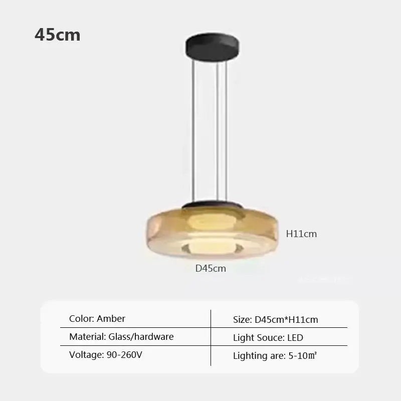 Modern gray and green tiered glass pendant light with amber-colored glass pendant and sleek black hardware for dining room