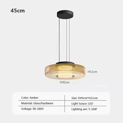 Modern gray and green tiered glass pendant light with amber-colored glass pendant and sleek black hardware for dining room