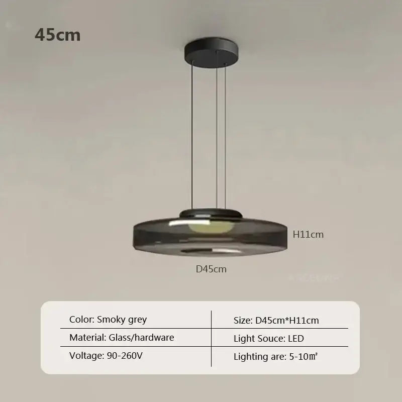 Modern gray and green tiered glass pendant light featuring a smoky grey glass pendant with black hardware suspension
