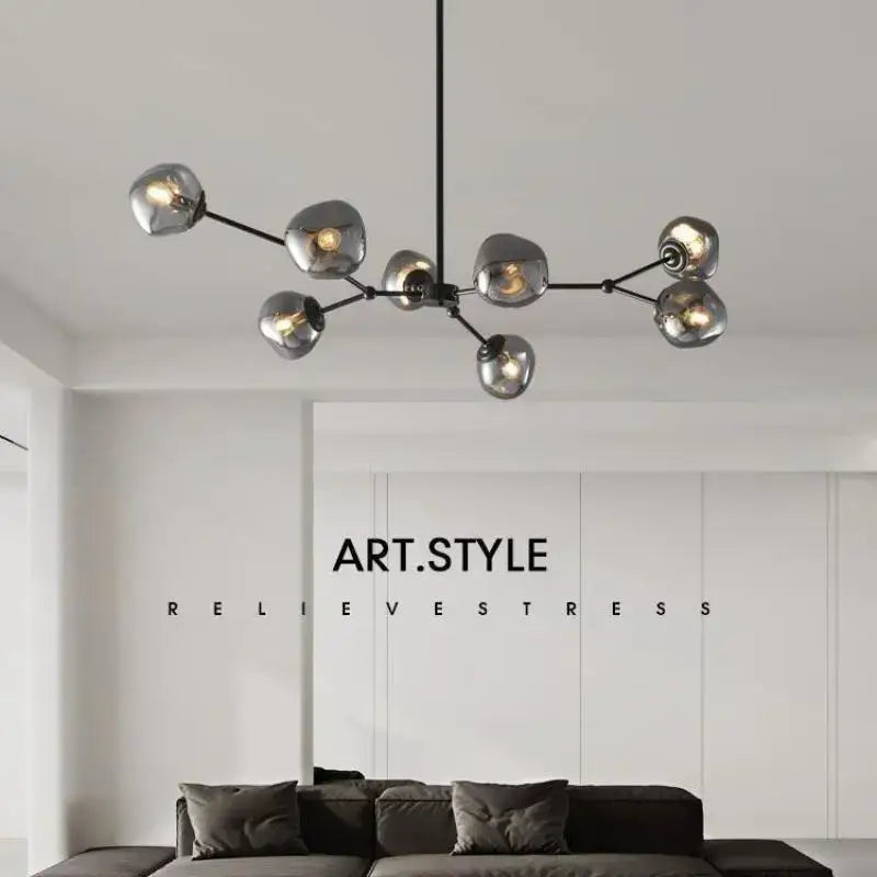 Modern black metal chandelier with seven frosted globe bulbs featuring gray lava glass for dining room lighting