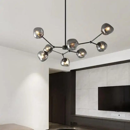 Modern black metal chandelier with frosted glass globe shades featuring gray lava glass for dining room lighting