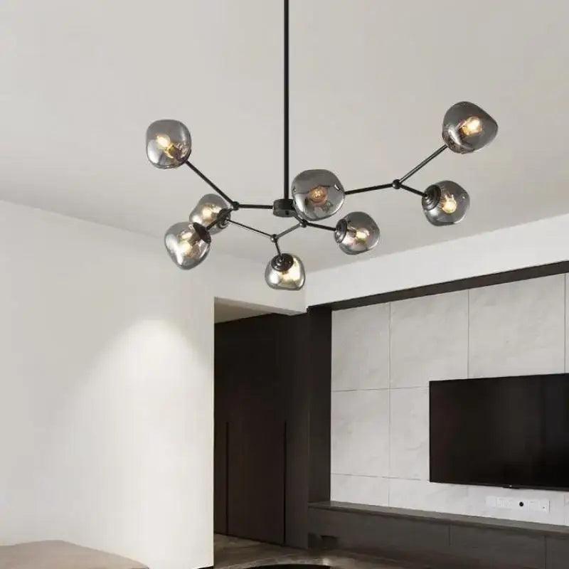 Modern black metal chandelier with frosted glass globe shades featuring gray lava glass for dining room lighting