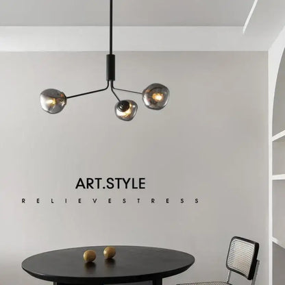 Modern black metal chandelier with three spherical smoked gray lava glass shades for dining room lighting