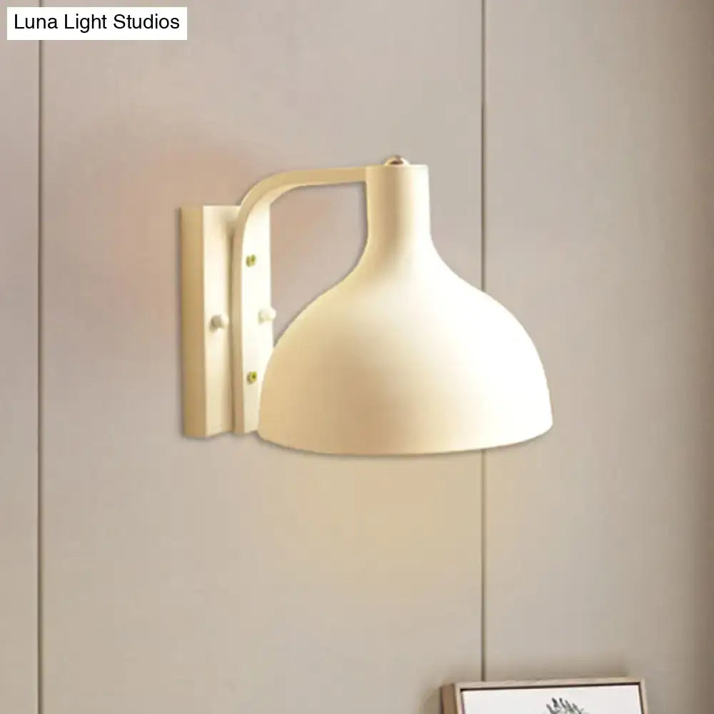 Modern gray metal domed wall sconce with cream-colored rounded shade and sleek bracket for adjustable hallway lighting
