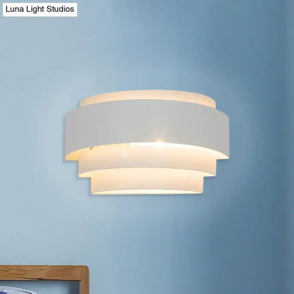 Modern gray metal wall sconce with etched pattern and warm glow ideal for living room lighting