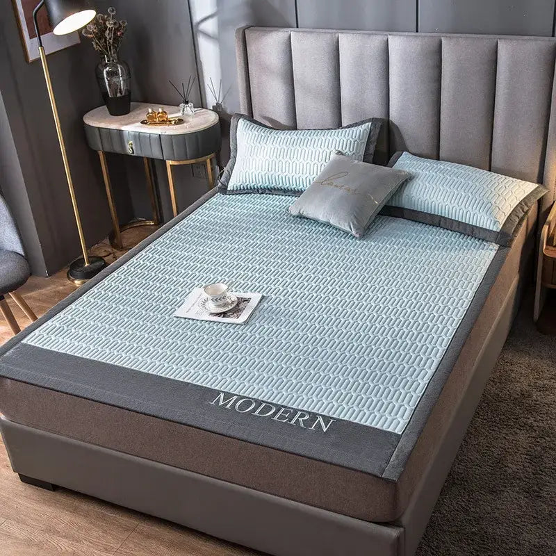 Light blue quilted cooling latex bed mat with gray border and modern embroidery for bedroom use