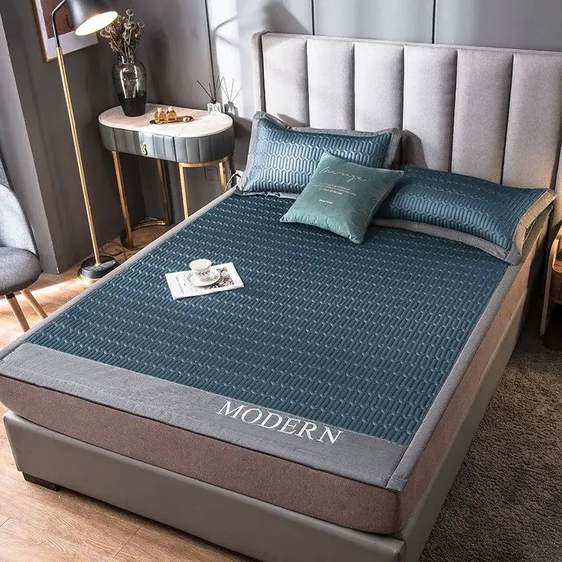Teal quilted cooling latex bed mat with gray border and modern embroidery for bedroom use
