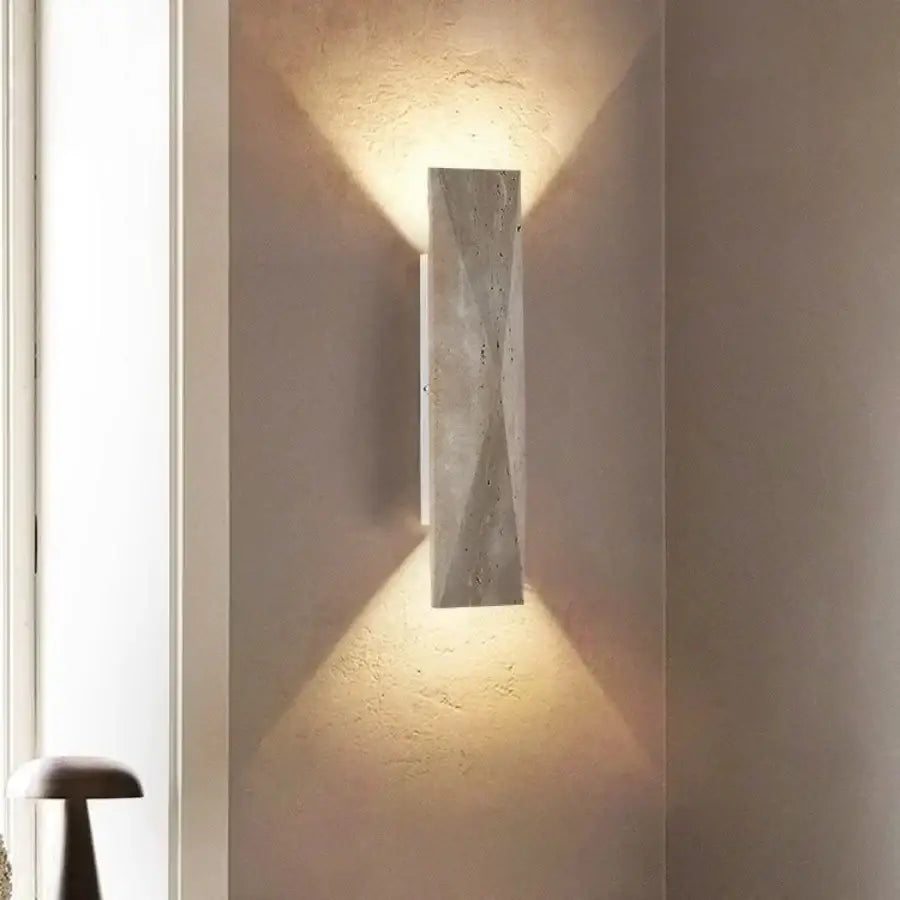 A sleek gray stone double led wall lamp with textured concrete surface designed as a modern bedroom sconce