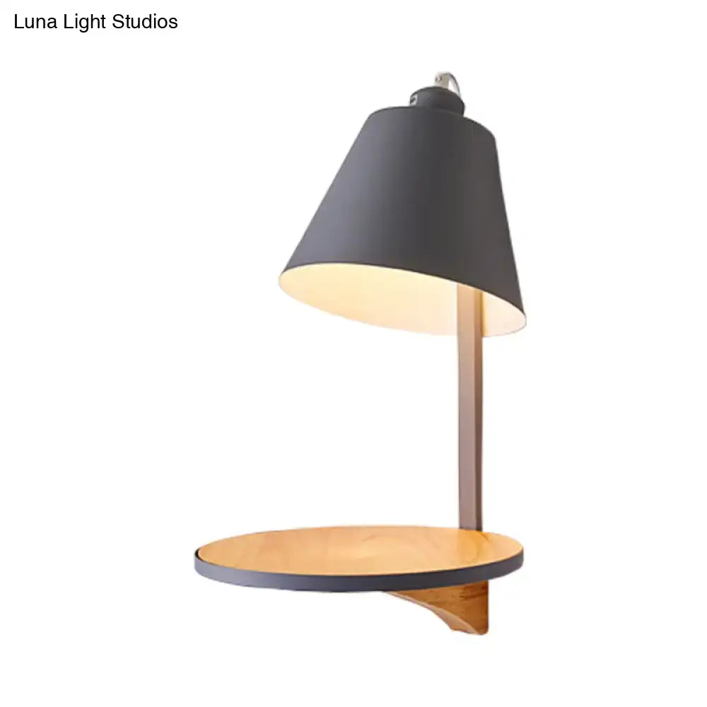 Modern black metal desk lamp with warm wooden shelf and base complementing gray tapered shade wall sconce