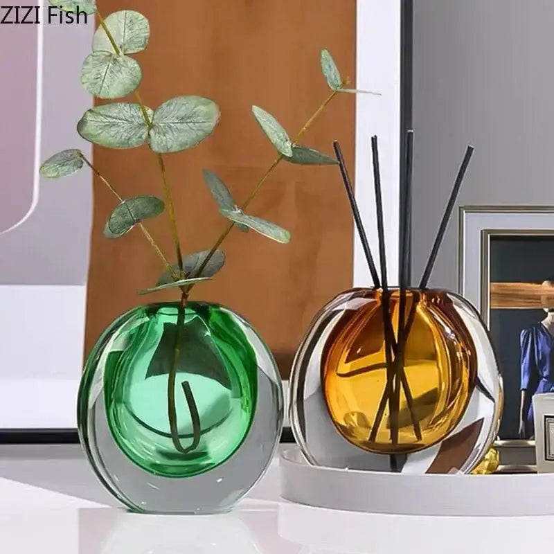 Two spherical emerald green and amber gold glass vases with clear bases for artificial flowers home decor