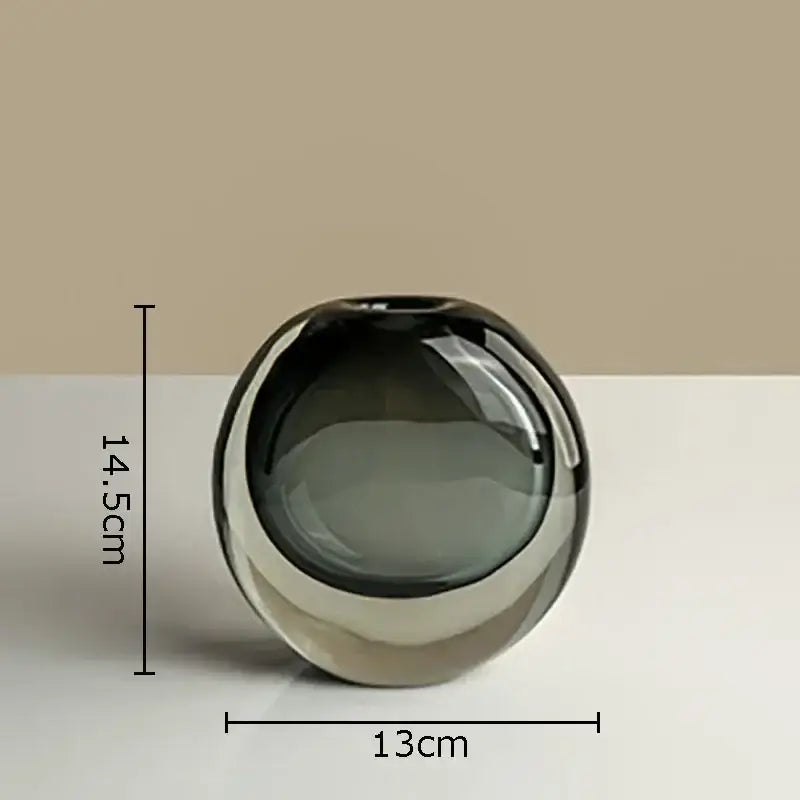 A sleek round glass vase in gradient gray with a glossy finish for artificial flowers home decor