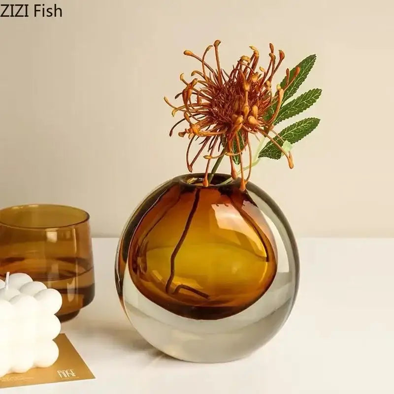 Modern gray and teal glass vase with a sleek two-toned amber and clear design featuring artificial flowers for home decor