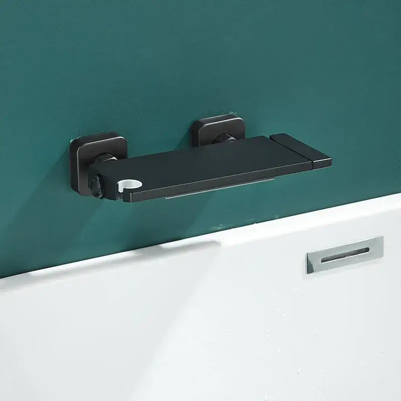 Black matte-finished wall mounted bathtub shelf with sleek design and circular cutout paired with modern gray wall mounted waterfall faucet set