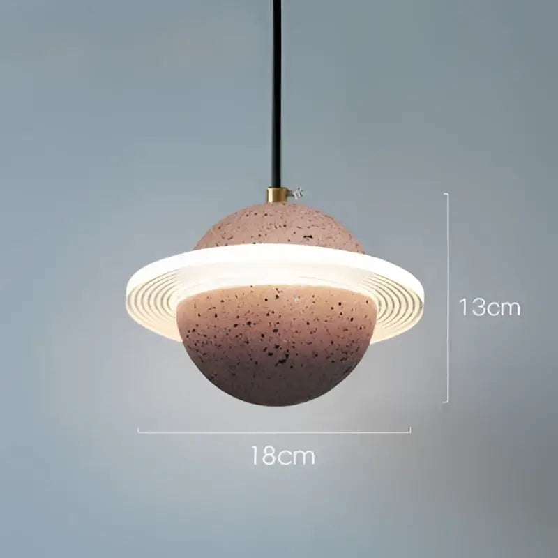 A modern gray and white cement planet pendant light with speckled terracotta sphere and black cord for decorbites decorbites cement planet pendant