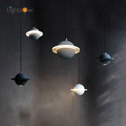 Sleek gray and white cement planet pendant light with textured spheres and glowing rings for modern bedroom decorbites decor