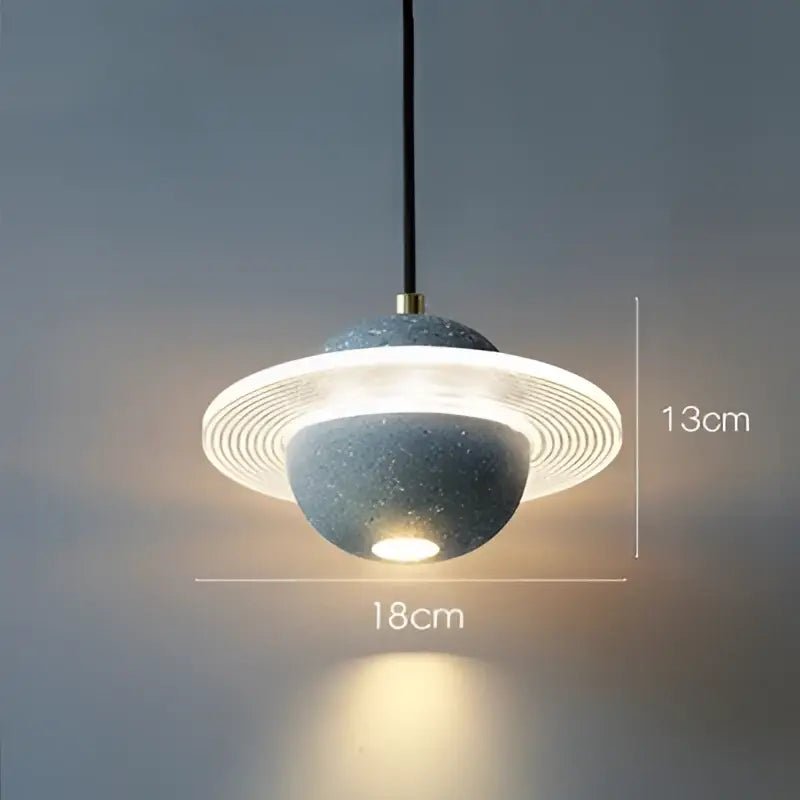 Modern gray and white cement planet pendant light with speckled spherical body and concentric rings for decorbites pendant light