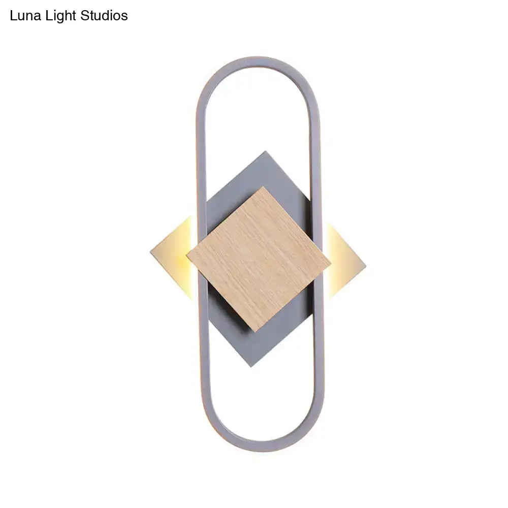 Modern gray and wood geometric LED wall sconce with sleek minimalist design providing white light for bedroom use