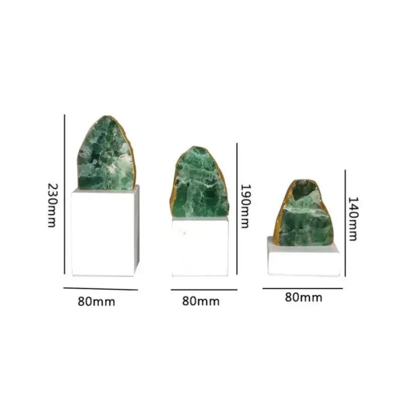 Three green aventurine geode specimens mounted on white bases as modern green agate crystal stone bookends