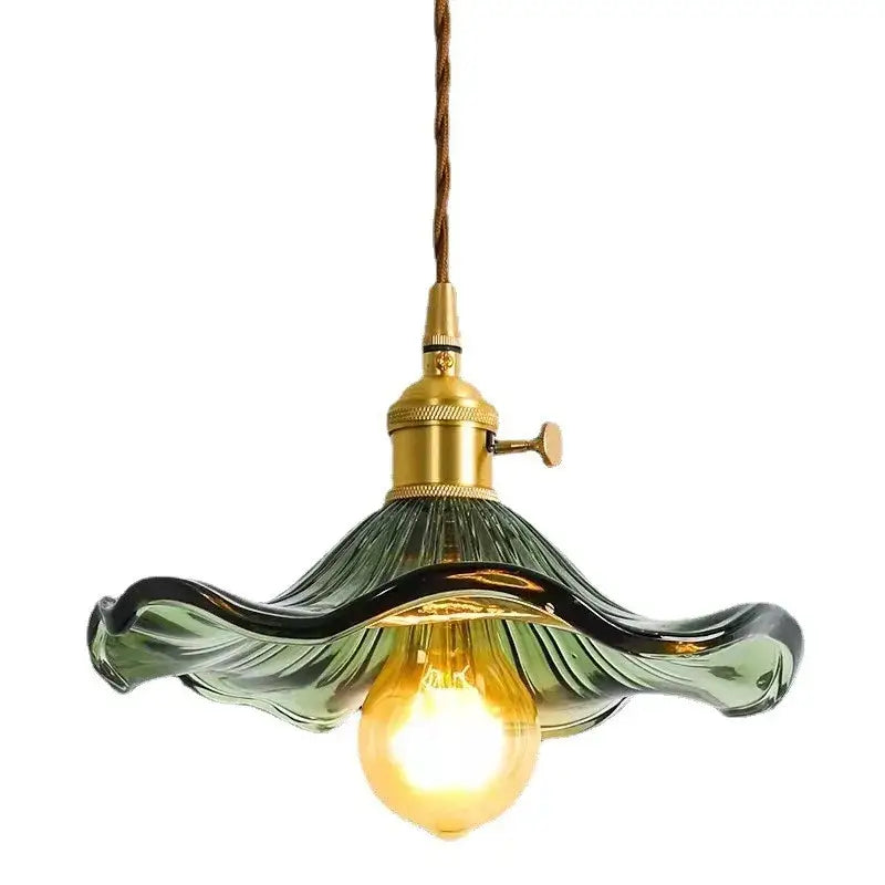 A modern green glass pendant light with brass fixture and exposed bulb for colorful glass cord pendant installation