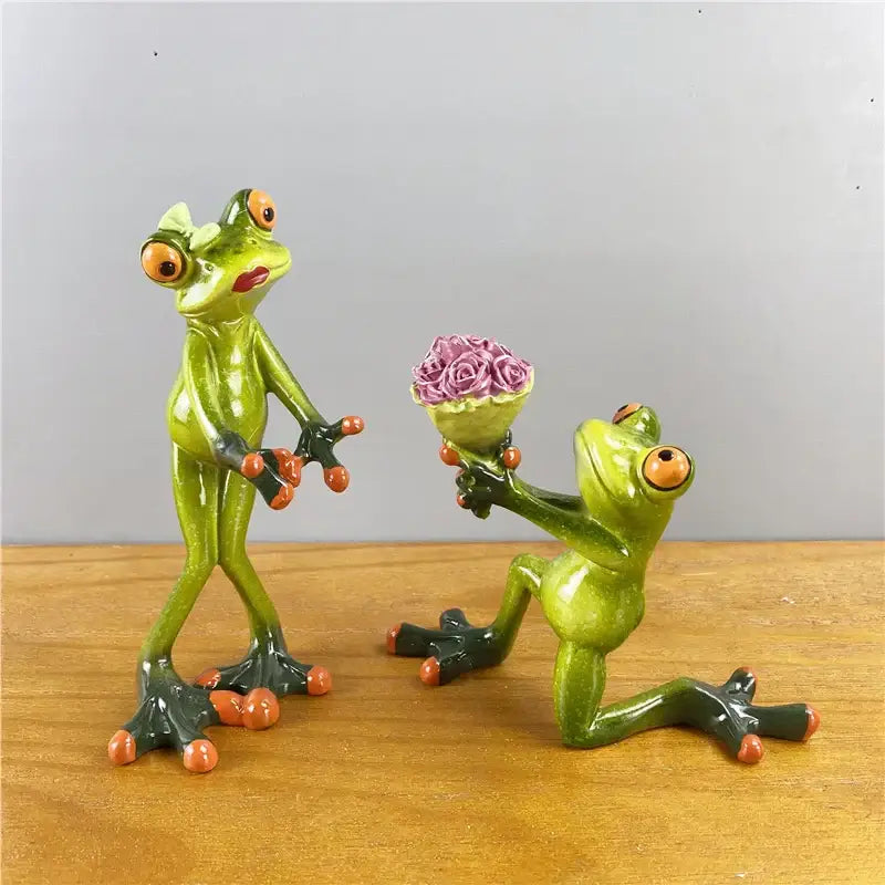 Modern green and orange leggy frog couple figurine with resin material holding purple roses for living room decorbites decor