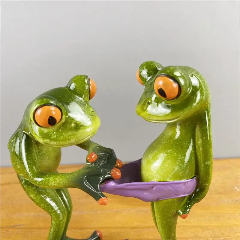Modern green and orange leggy frog couple figurine made of resin with playful poses for living room decorbites decor