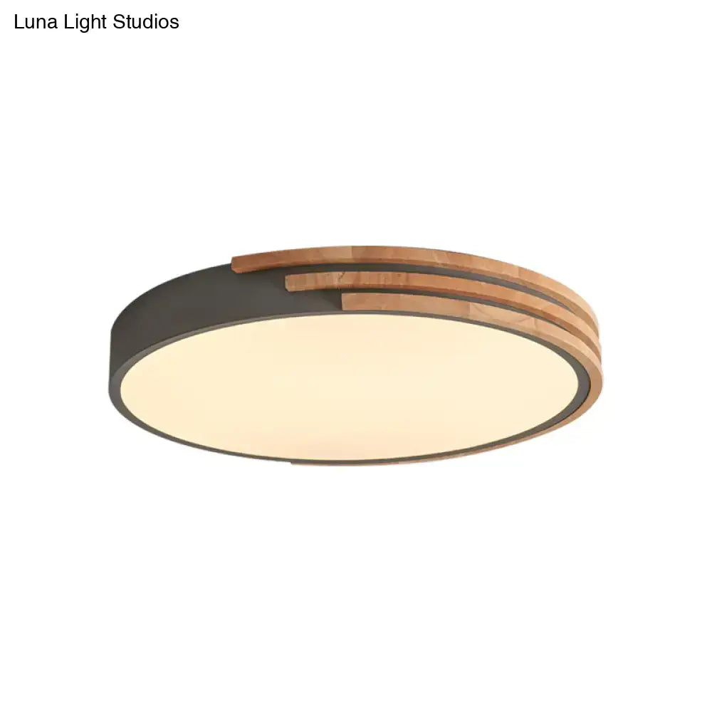 Modern DecorBites™ round flush mount ceiling light with warm glow, dark matte metal rings, and natural wood slats