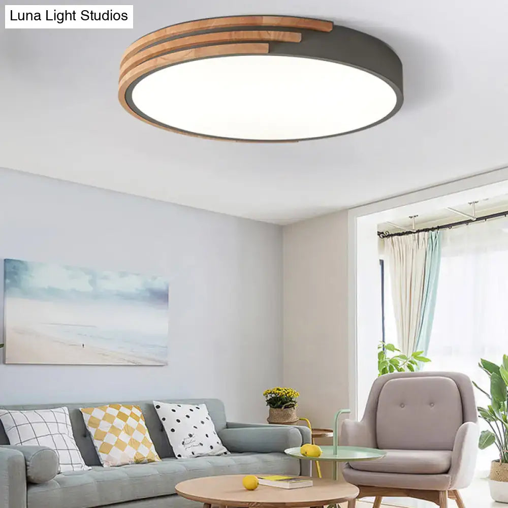 Modern round flush mount ceiling light by decorbites with dark metal frame and concentric wooden slats in grey and white