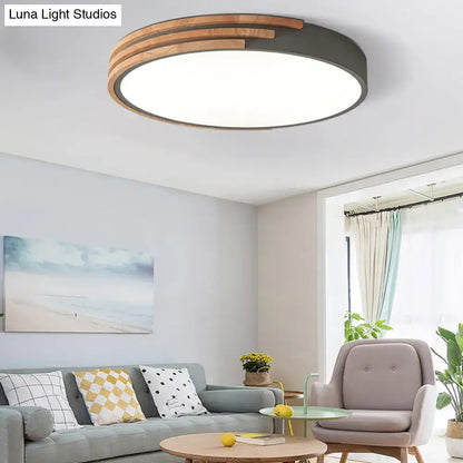 Modern round flush mount ceiling light with dark metal frame and concentric wooden slats by decorbites in grey and white