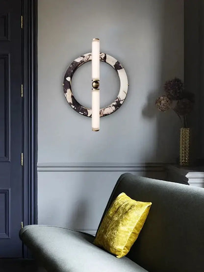 Modern wall lamp with green black marble circular base, frosted glass tubes, and gold-toned accent for bedroom use