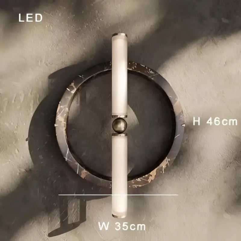 Modern wall lamp with a sleek cylindrical white LED body and a green black marble circular base for bedroom use