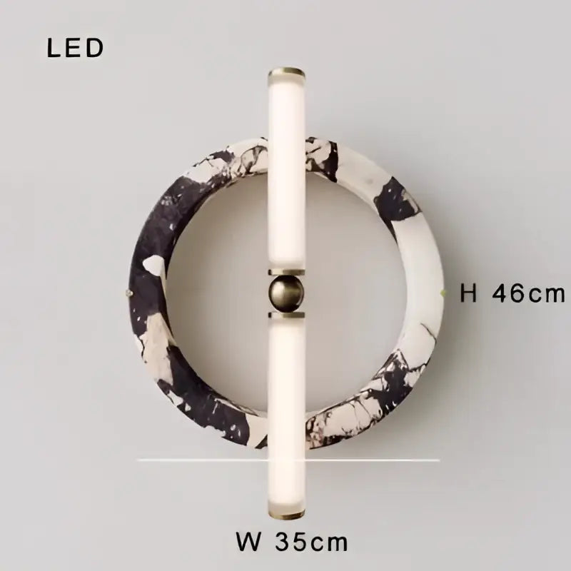 Modern wall lamp with a white marble circular base and sleek cylindrical fixture for bedroom green black marble decor