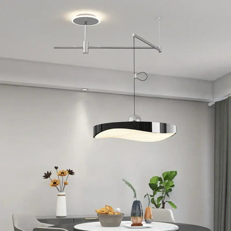 Modern black and chrome pendant light chandelier with sleek curved design and metallic arm for dining room use
