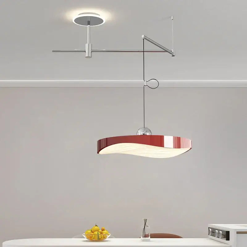 Modern red and white pendant light chandelier with sleek curved design and metallic arm for dining room lighting