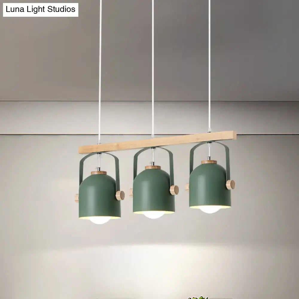 Modern green metal pendant lights with wooden accents hang from a light wood beam in a decorbites dome island light chandelier