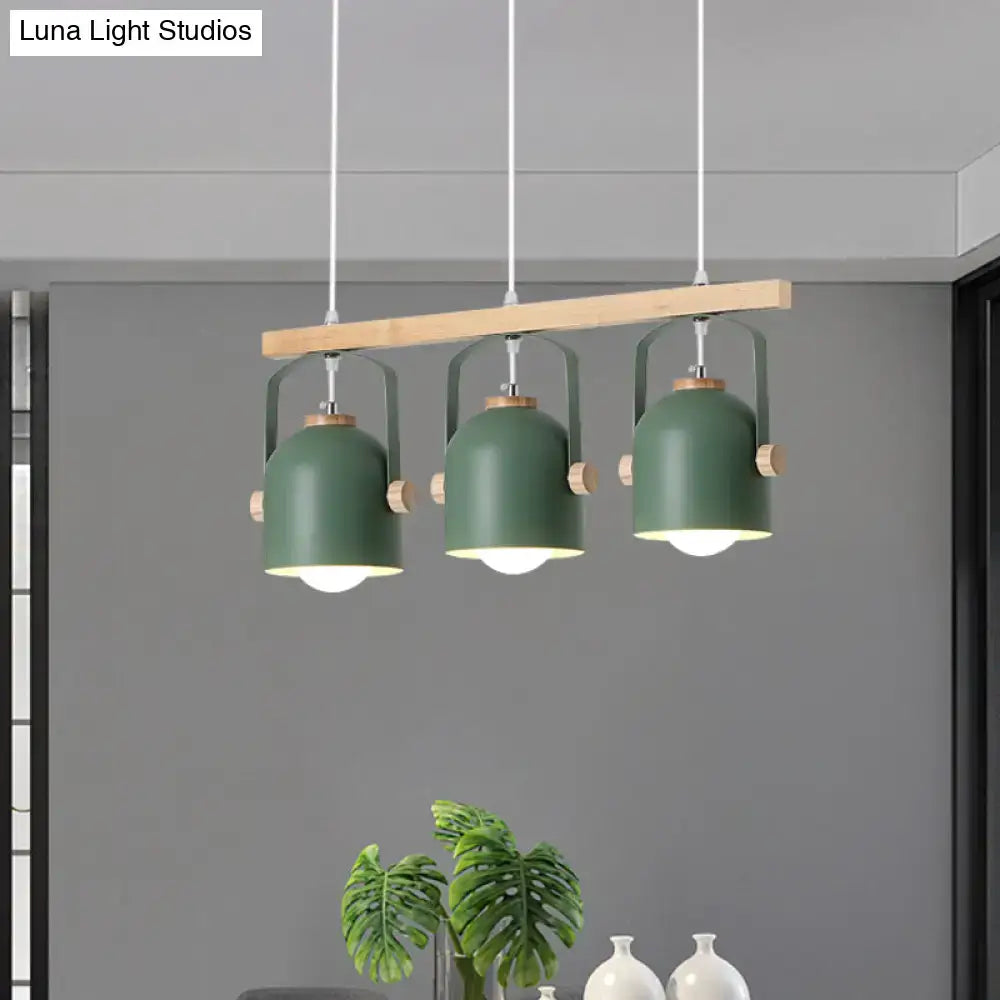 Modern green metal pendant dome island light with wooden accents hanging from a light wood beam by decorbites