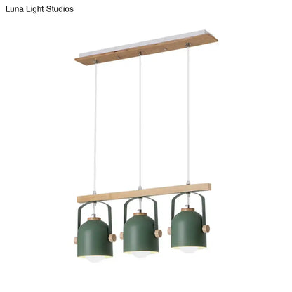 Modern green metal dome island light with wooden accents featuring three hanging lampshades by decorbites