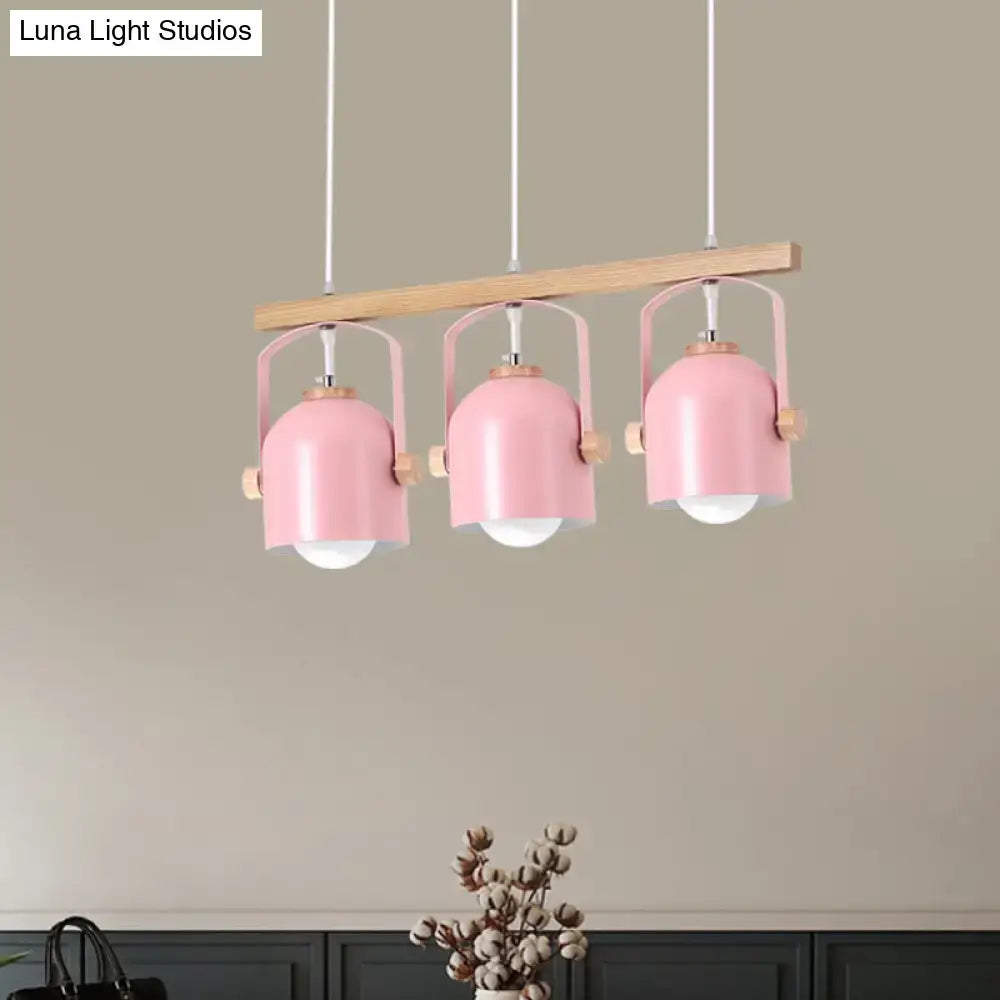 Pink metal pendant dome island light with wooden accents hanging from light wood bar in decorbites chandelier