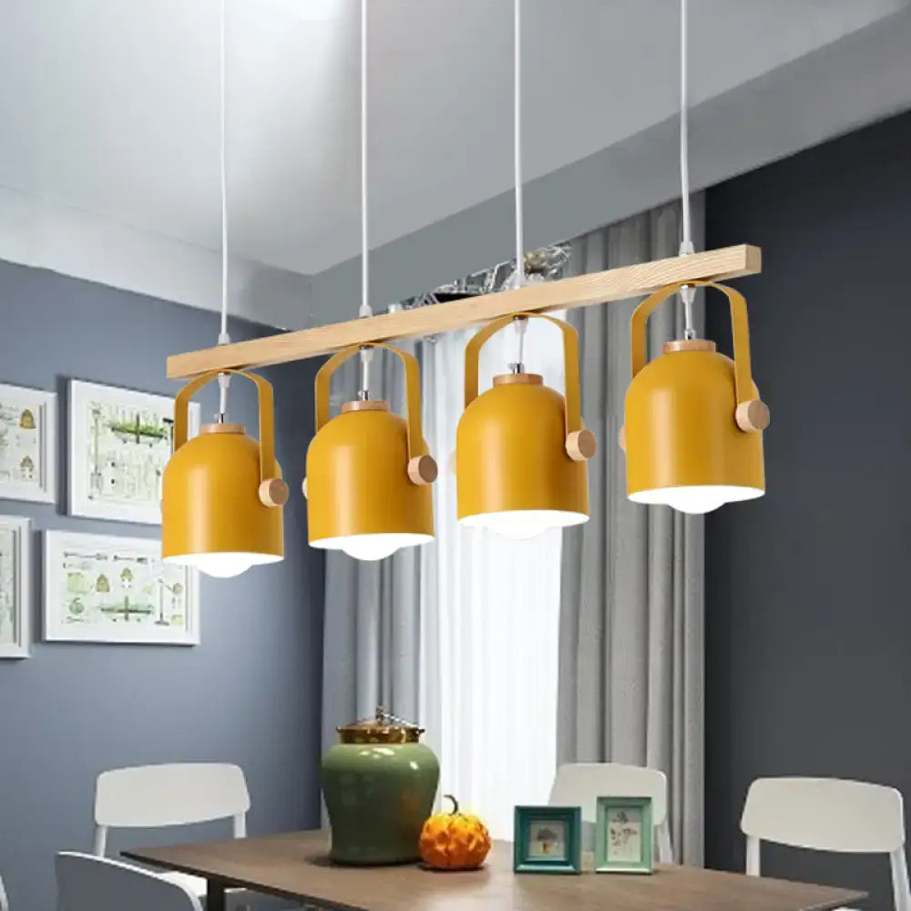 Modern yellow dome island light with wooden accents and metal shade hanging above a dining table