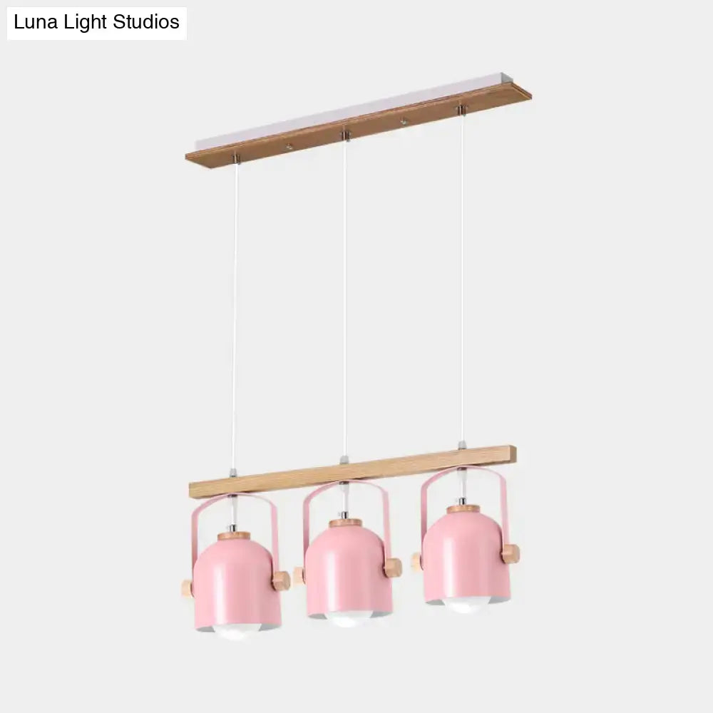 Decorbites nordic dome island light with three pink metal pendant lights and wooden accents on rectangular wood frame