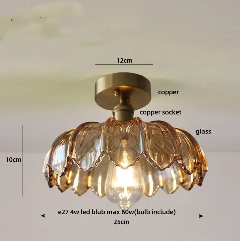 A modern amber glass flush mounted ceiling light with copper base and petal-shaped shades for bedroom use