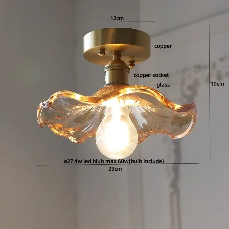 Modern green glass leaf flush mounted ceiling light with warm-toned hand-blown glass and copper-finished base