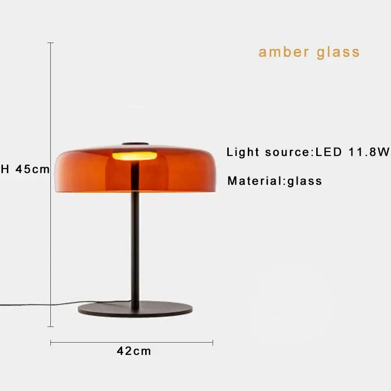 Amber glass table lamp with sleek black metal base and stem complements modern green glass table designs for bedrooms