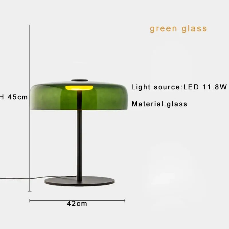 A modern table lamp with a translucent green glass shade and black metal base perfect for bedroom use
