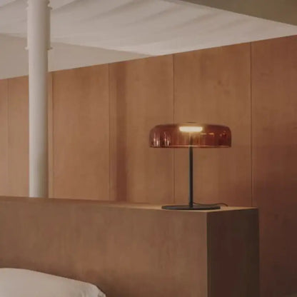 Modern green glass table lamp for bedroom featuring a sleek amber-tinted glass shade with a black metal base and led bulb
